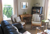 The Living Room/Study is warmly furnished with comfortable chairs, an antique dining table, Persian rug and books and magazines - perfect for reflecting, reading and conversation. TV, CD and DVD player also on hand. 
