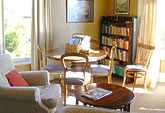 The Living Room/Study is warmly furnished with comfortable chairs, an antique dining table, Persian rug and books and magazines - perfect for reflecting, reading and conversation. 